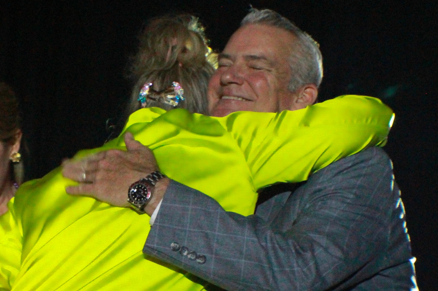 head of school and honoree embrace in a hug